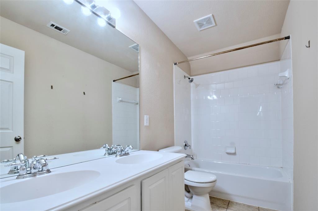 2012 Trinity Lane McKinney, TX 75072 - Photo 21 of 32 a bathroom with a granite countertop sink a toilet and shower