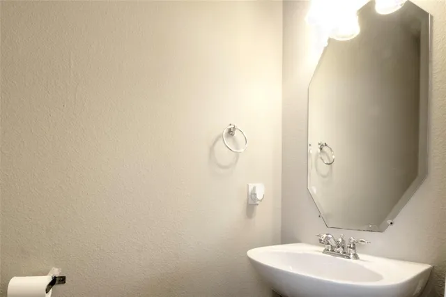 a bathroom with a sink and mirror