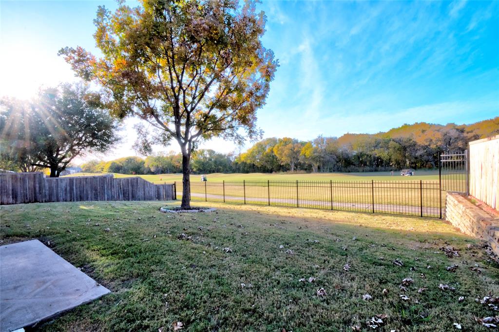 2012 Trinity Lane McKinney, TX 75072 - Photo 5 of 32 a view of a yard with wooden fence