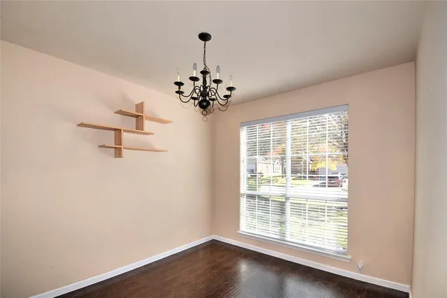 a view of a livingroom with a window and wooden floor
