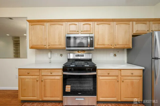 a kitchen with wooden cabinets and a stove top oven