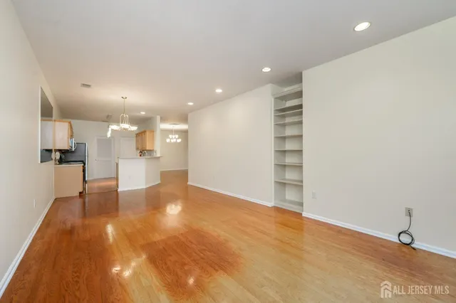 a view of a kitchen with a sink and a refrigerator