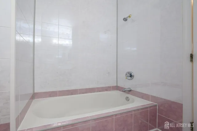 a bathroom with a tub and shower