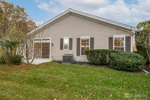a view of a house with a yard and deck