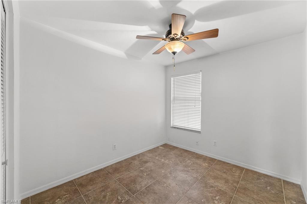 1700 42nd Terrace Southwest Naples, FL 34116 - Photo 12 of 27 Spare room with a ceiling fan and baseboards