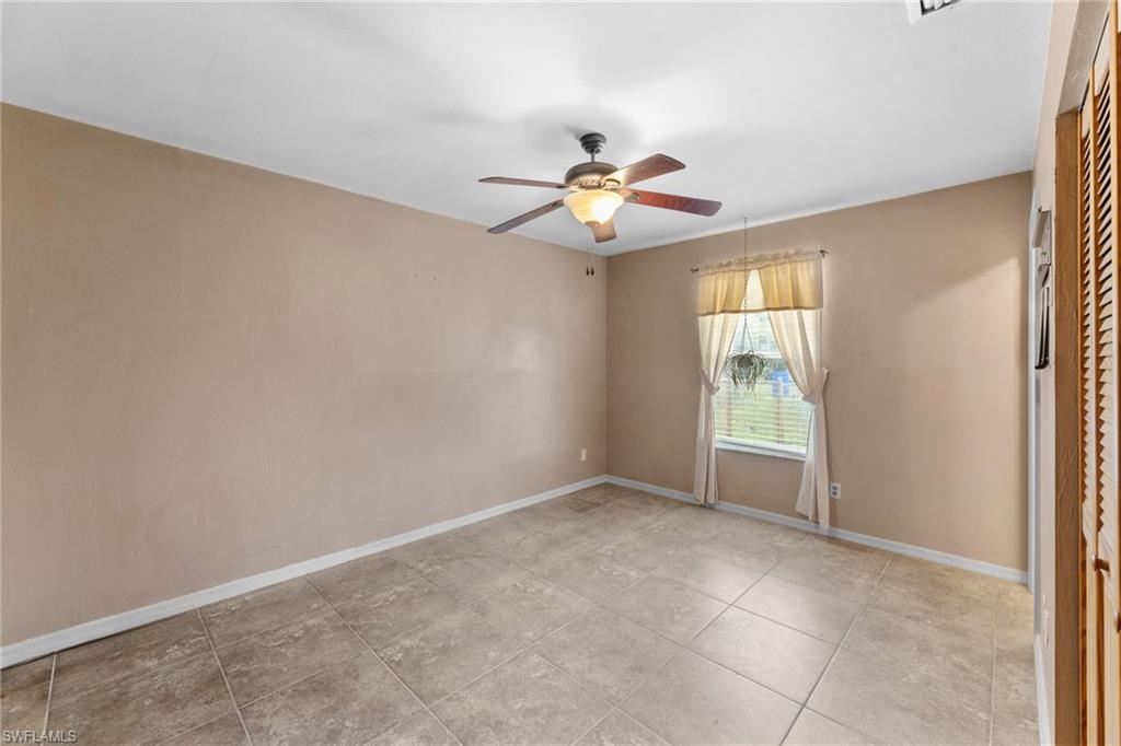 1700 42nd Terrace Southwest Naples, FL 34116 - Photo 13 of 27 Spare room with ceiling fan and baseboards