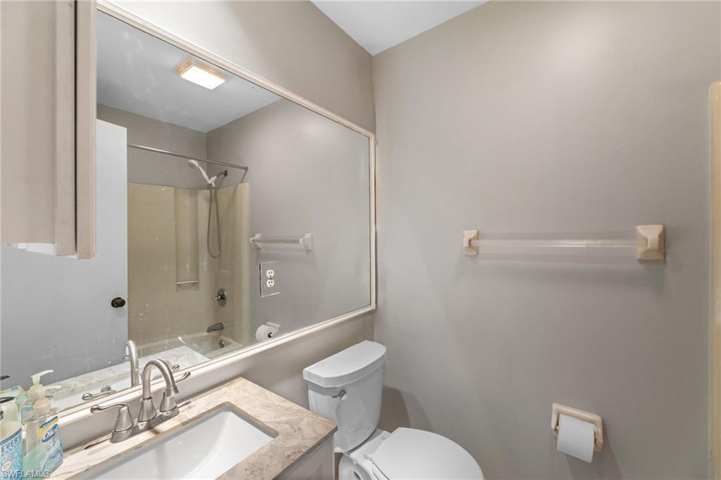 1700 42nd Terrace Southwest Naples, FL 34116 - Photo 16 of 27 Bathroom featuring toilet, tub / shower combination, and vanity