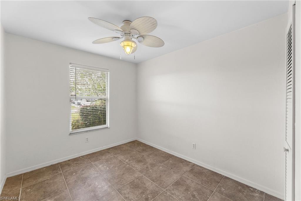 1700 42nd Terrace Southwest Naples, FL 34116 - Photo 18 of 27 Empty room with tile patterned flooring, baseboards, and a ceiling fan