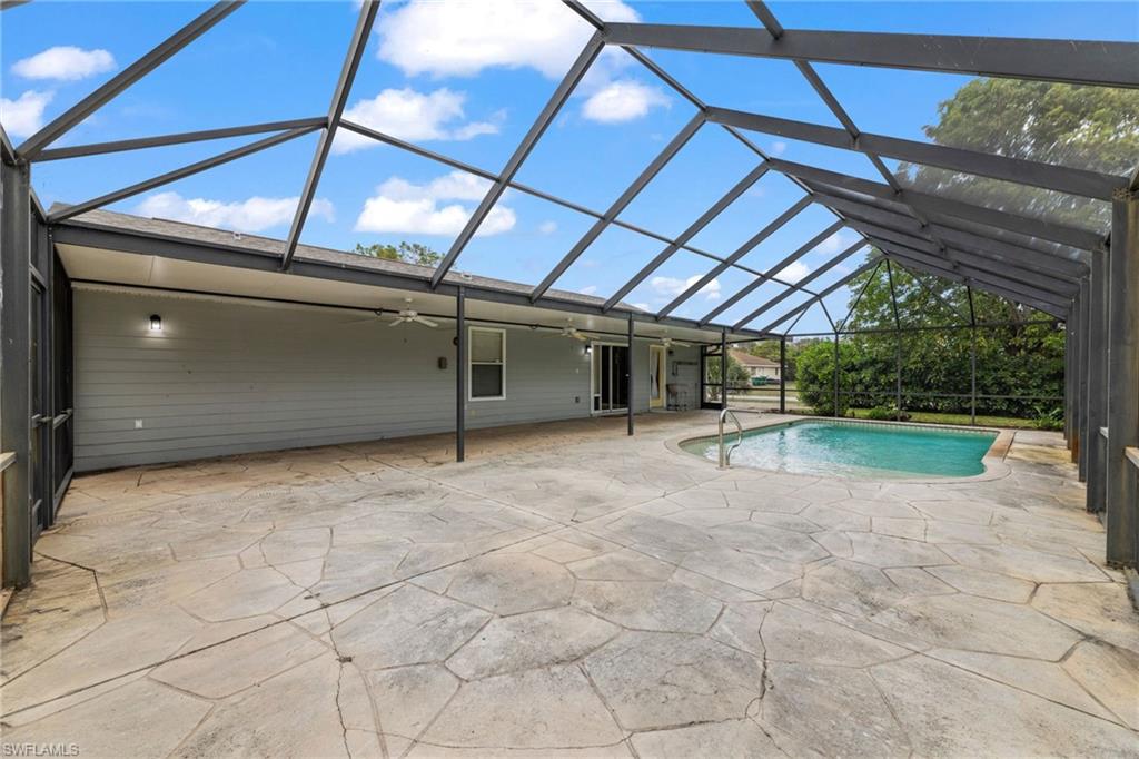 1700 42nd Terrace Southwest Naples, FL 34116 - Photo 20 of 27 Outdoor pool with glass enclosure and a patio
