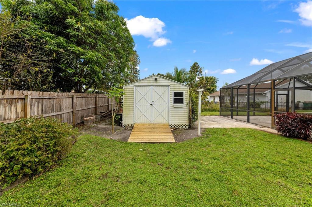 1700 42nd Terrace Southwest Naples, FL 34116 - Photo 23 of 27 View of shed featuring a fenced backyard