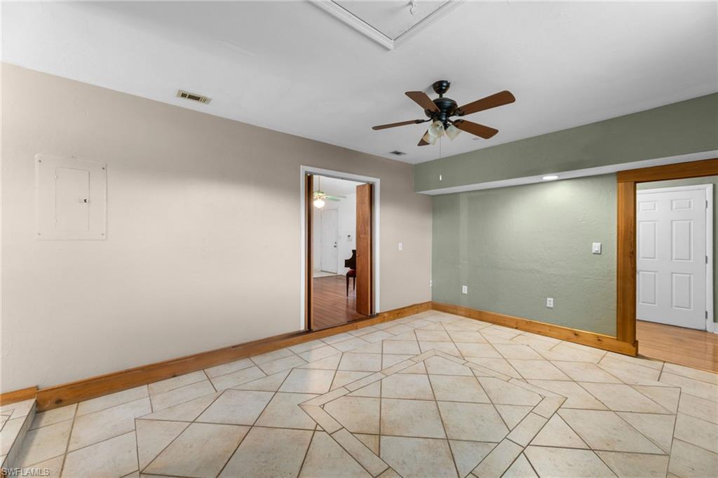 1700 42nd Terrace Southwest Naples, FL 34116 - Photo 26 of 27 Spare room with light tile patterned floors, ceiling fan, visible vents, baseboards, and electric panel