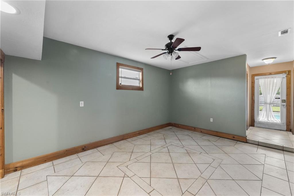 1700 42nd Terrace Southwest Naples, FL 34116 - Photo 27 of 27 Unfurnished room featuring light tile patterned floors, a ceiling fan, visible vents, and baseboards