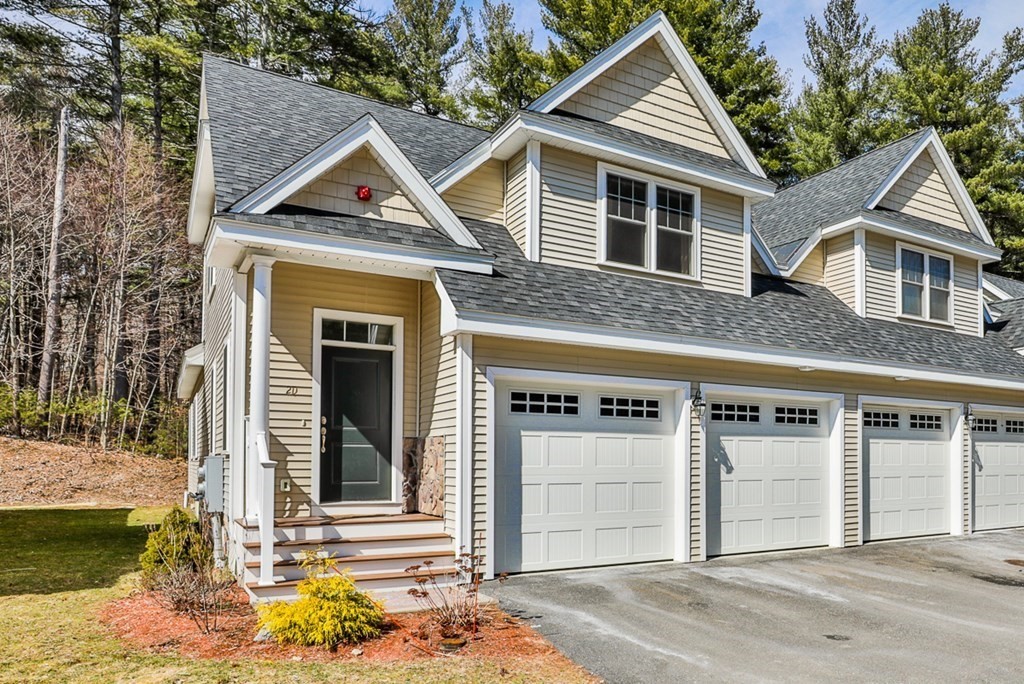 2 Trail Ridge Way, Unit D Harvard, MA 01451 - Photo 1 of 31 a front view of a house with a yard garage and windows