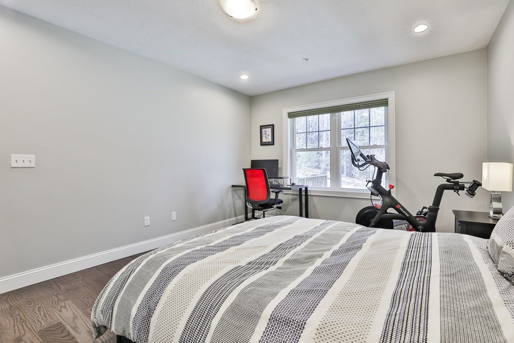 2 Trail Ridge Way, Unit D Harvard, MA 01451 - Photo 19 of 31 a bedroom with a bed and wooden floor