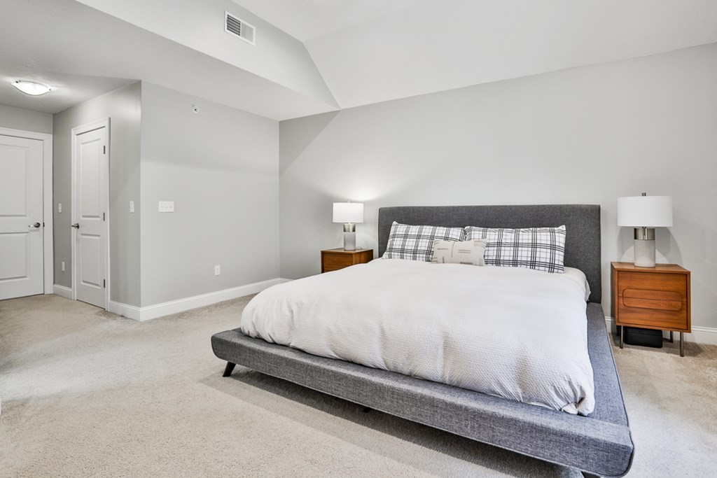 2 Trail Ridge Way, Unit D Harvard, MA 01451 - Photo 27 of 31 a bedroom with a bed and a chair