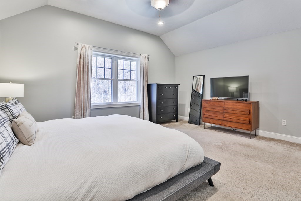 2 Trail Ridge Way, Unit D Harvard, MA 01451 - Photo 28 of 31 a bedroom with a bed and a television