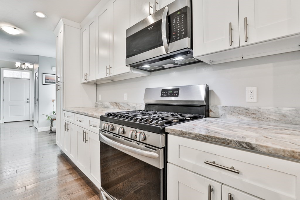 2 Trail Ridge Way, Unit D Harvard, MA 01451 - Photo 5 of 31 a kitchen with stainless steel appliances granite countertop a stove and a microwave
