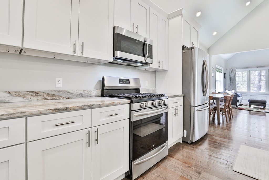 2 Trail Ridge Way, Unit D Harvard, MA 01451 - Photo 6 of 31 a kitchen with stainless steel appliances granite countertop a stove a sink and a microwave