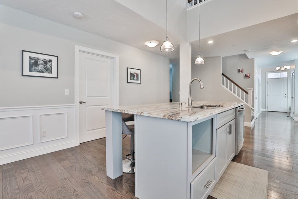 2 Trail Ridge Way, Unit D Harvard, MA 01451 - Photo 8 of 31 a kitchen with granite countertop white cabinets and white appliances