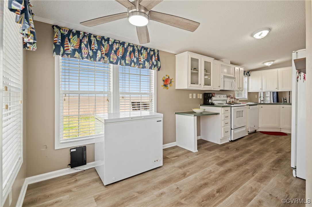 374 James River Overview Spring Grove, VA 23881 - Photo 28 of 49 a kitchen with a refrigerator a sink and dishwasher with wooden floor