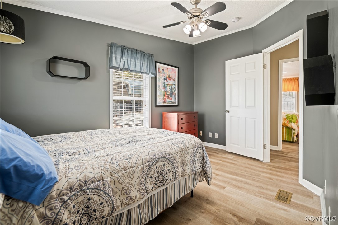 374 James River Overview Spring Grove, VA 23881 - Photo 40 of 49 a bedroom with a large bed chandelier and a window