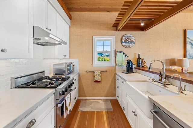 a kitchen with stainless steel appliances a stove a sink and a refrigerator