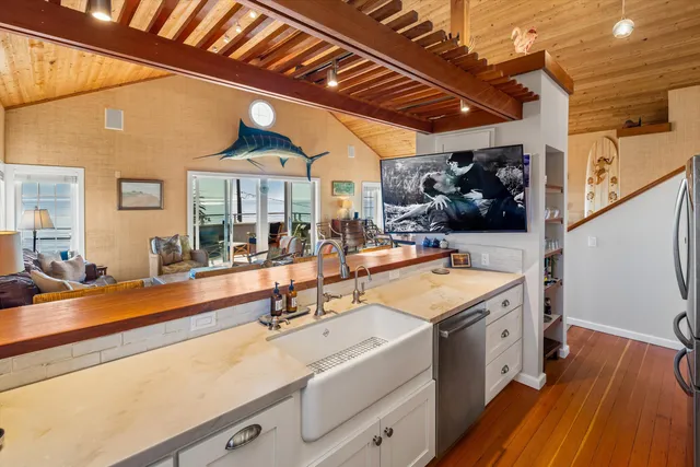 a view of a kitchen with a sink and wooden floor