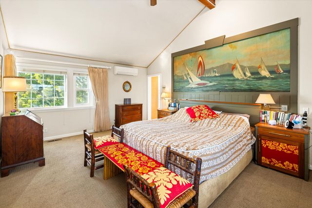 a bed room with a bed and a large window