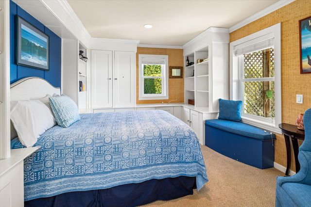 a bedroom with a bed wooden floor and window