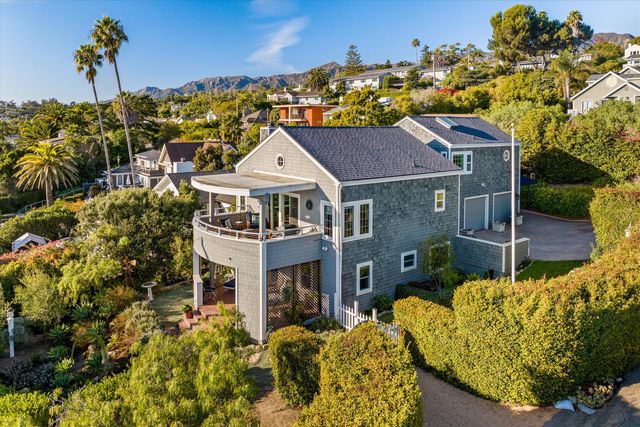 a aerial view of a house with a yard and potted plants