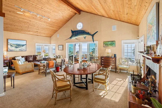 a living room with fireplace furniture and a large window