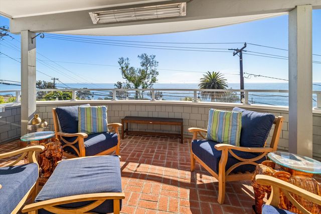 a outdoor dining space with furniture and potted plants