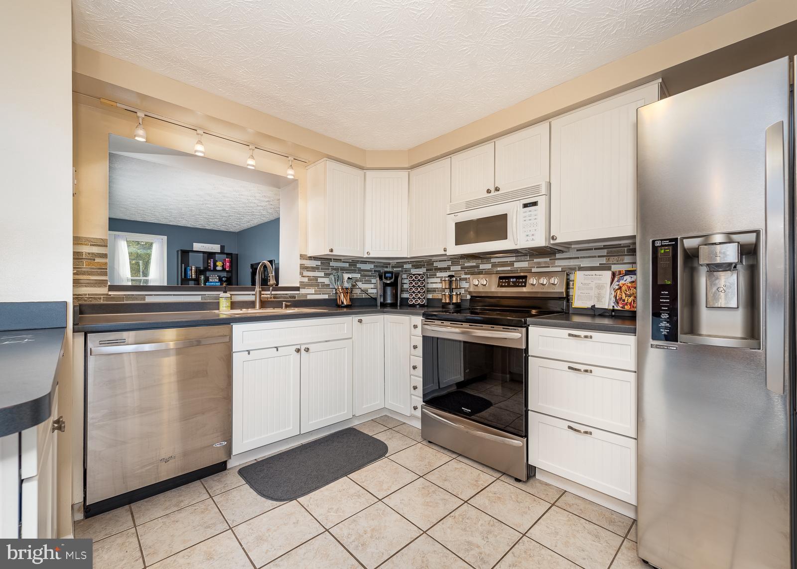 9 Rader Court Baltimore, MD 21234 - Photo 7 of 24 White cabinets and stainless steel appliances