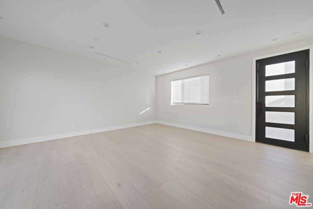 17443 Valerio Street Van Nuys, CA 91406 - Photo 18 of 30 wooden floor in an empty room with a window