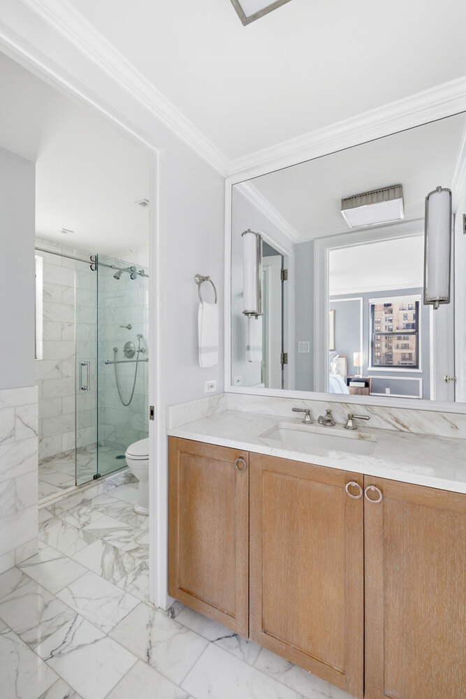 110 East 36th Street, Unit 12B Manhattan, NY 10016 - Photo 10 of 16 a bathroom with a granite countertop sink mirror and shower