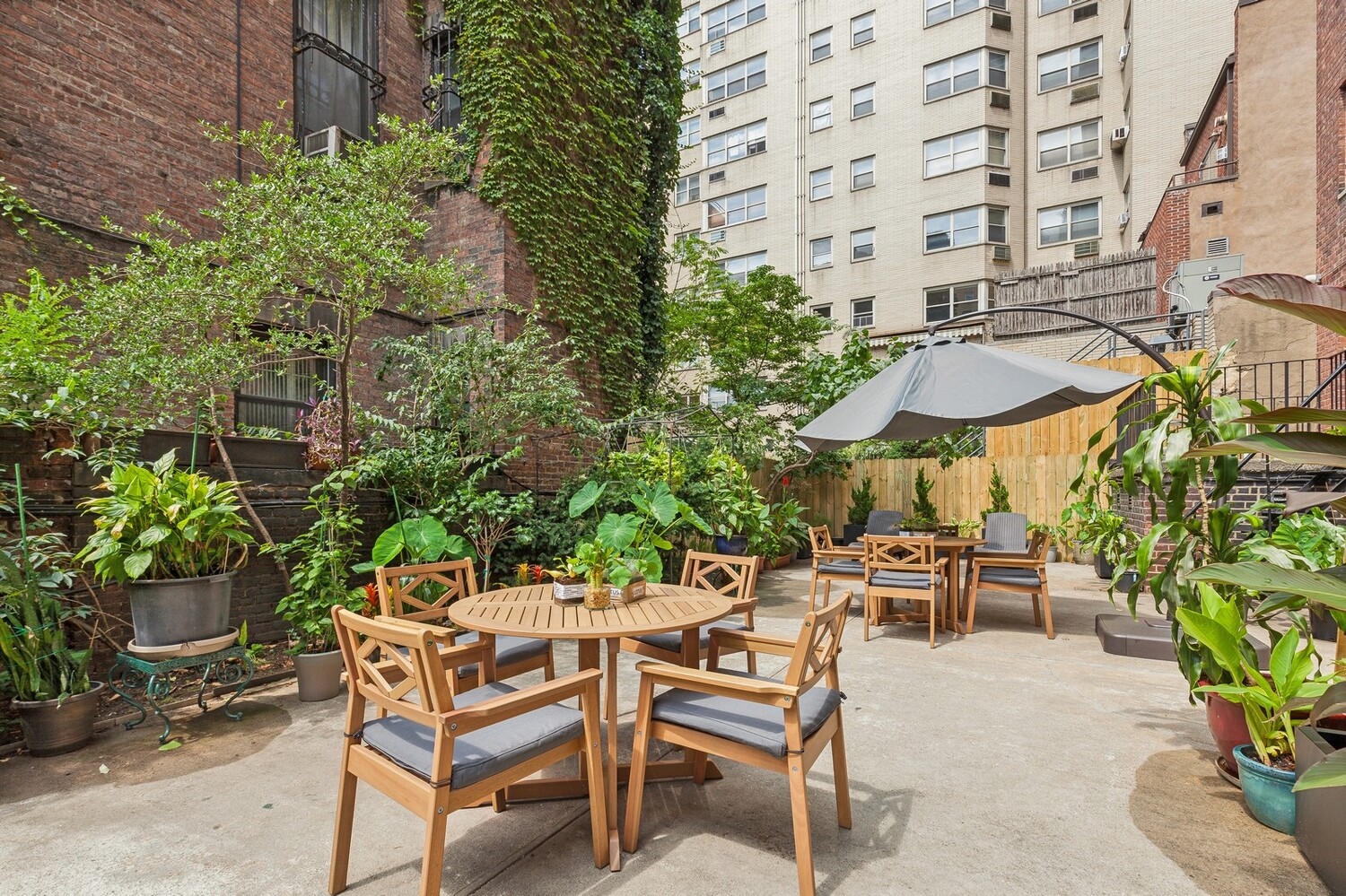 110 East 36th Street, Unit 12B Manhattan, NY 10016 - Photo 13 of 16 a patio with table and chairs and potted plants