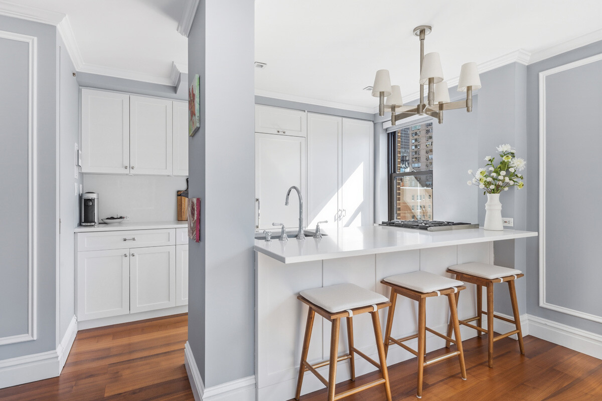 110 East 36th Street, Unit 12B Manhattan, NY 10016 - Photo 2 of 16 a kitchen with stainless steel appliances cabinets and a table
