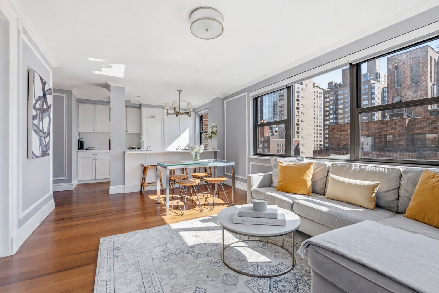 110 East 36th Street, Unit 12B Manhattan, NY 10016 - Photo 5 of 16 a living room with furniture and a large window