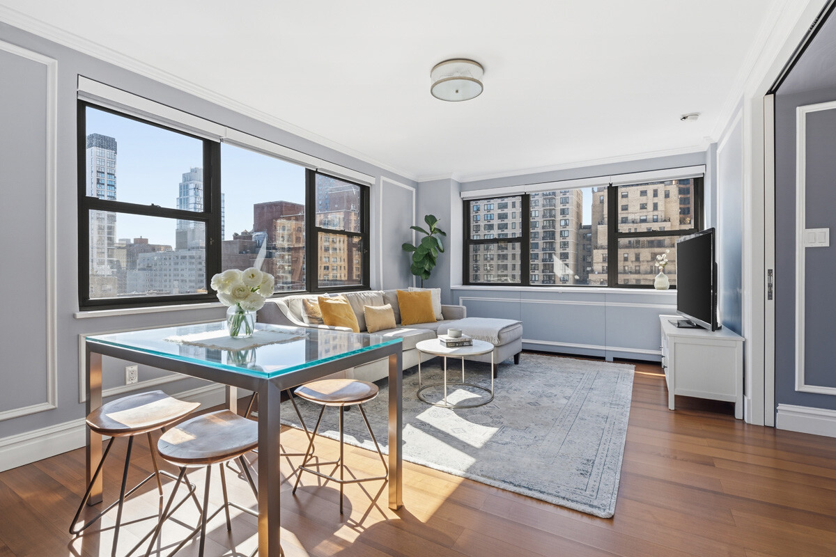 110 East 36th Street, Unit 12B Manhattan, NY 10016 - Photo 6 of 16 a living room with furniture and a floor to ceiling window