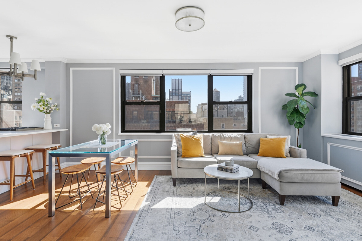 110 East 36th Street, Unit 12B Manhattan, NY 10016 - Photo 7 of 16 a living room with furniture and a large window
