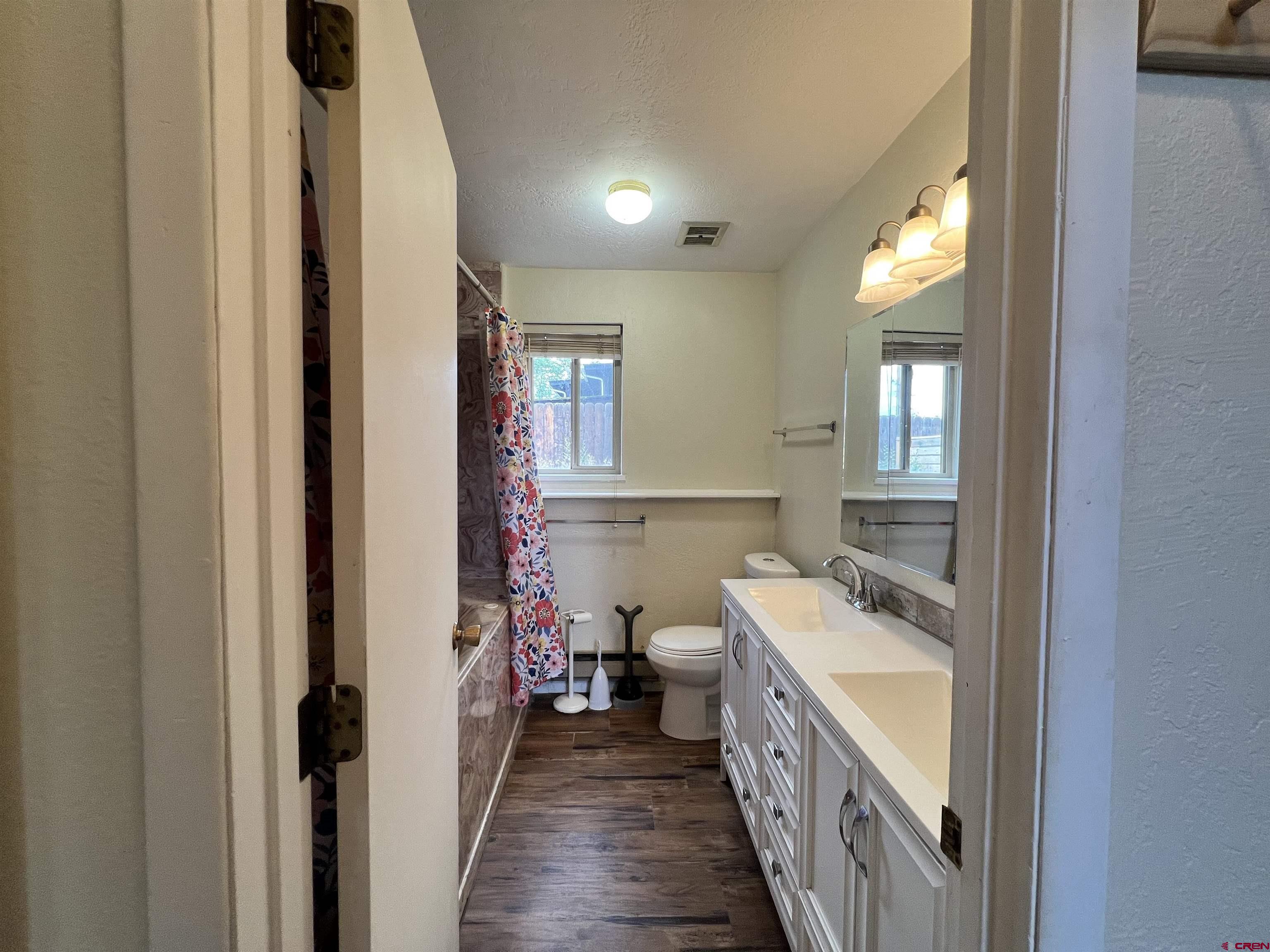1328 Jackson Street Cortez, CO 81321 - Photo 22 of 37 a bathroom with a double vanity sink and a mirror