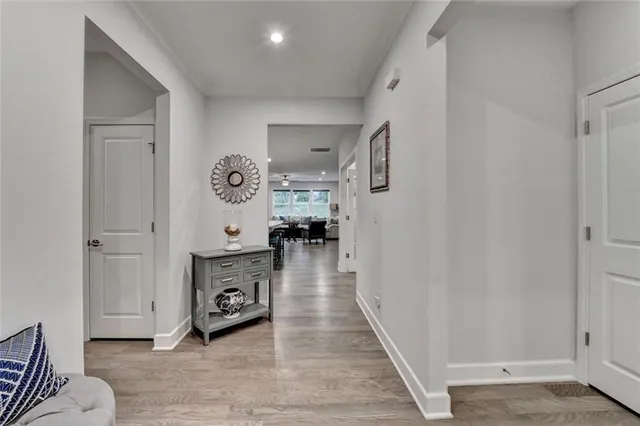 a view of a hallway with wooden floor and furniture