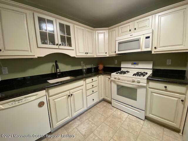 15 Andover Road Jackson, NJ 08527 - Photo 3 of 14 a kitchen with granite countertop white cabinets and white appliances