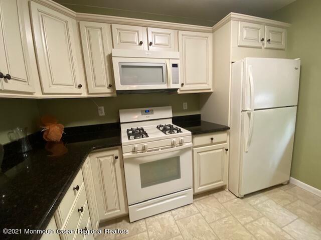 15 Andover Road Jackson, NJ 08527 - Photo 4 of 14 a kitchen with white cabinets and white appliances