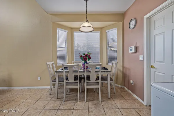 a view of a dining room with furniture and window