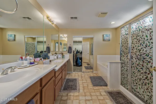 a bathroom with a double vanity sink and a mirror