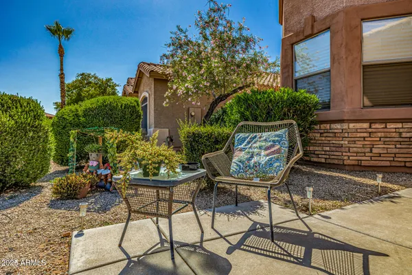 a view of a chairs and table in a backyard