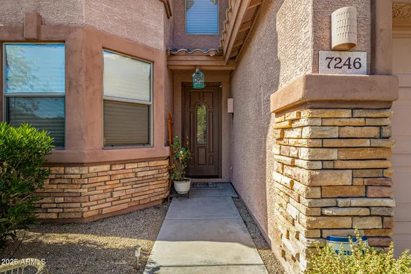 a view of front door of house with stairs