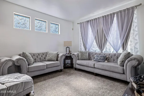 a living room with a couch and a large window