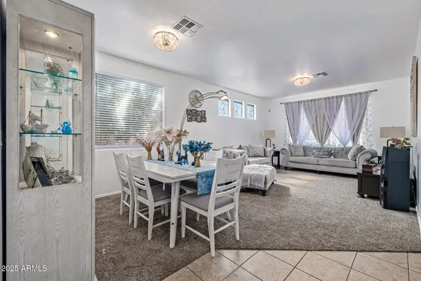 a dining room with furniture and a chandelier